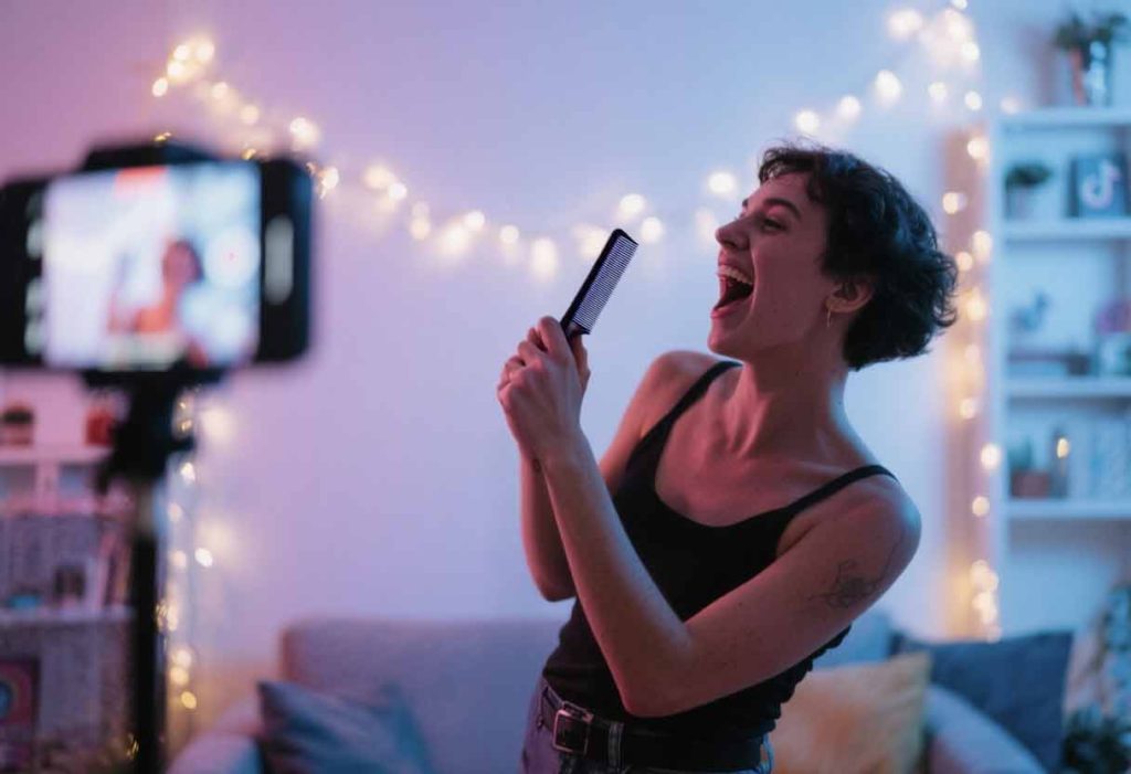 Influencer-style pantomime scene with a person holding a fake mic like a TikTok ad.